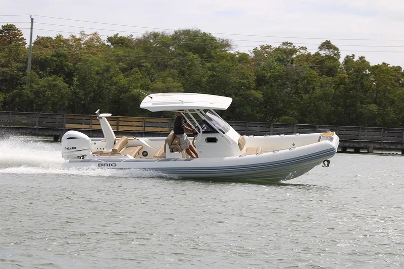 Slide: The Image of 2026 Brig Eagle 8 boat cruising on water with Yamaha engine, surrounded by lush greenery. - 7