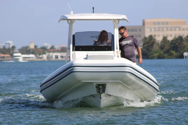 Slide: The Image of 2026 Brig Eagle 8 boat cruising on a sunny day with two passengers. - 8