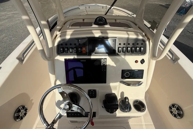 Slide: The Image of 2021 Grady-White Fisherman 236 boat dashboard with steering wheel and control panel. - 12