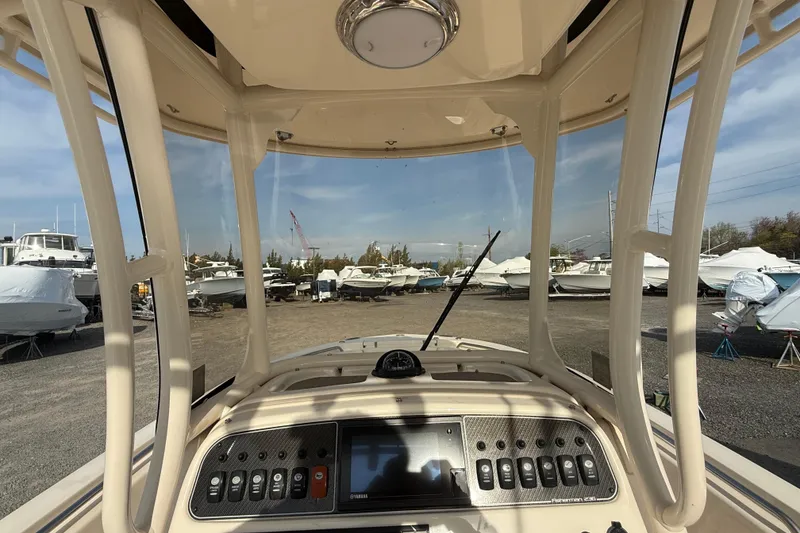 Slide: The Image of 2021 Grady-White Fisherman 236 dashboard view in a boatyard setting. - 13