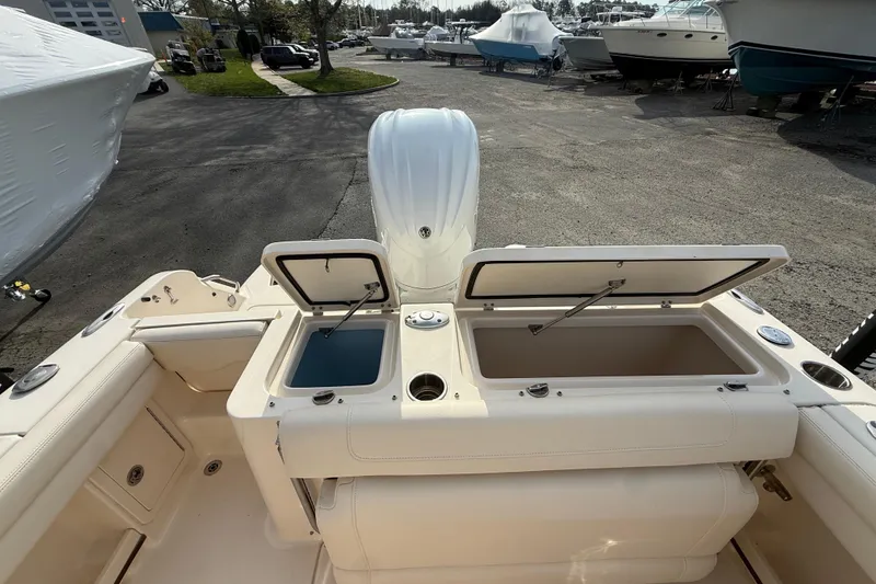 Slide: The Image of 2021 Grady-White Fisherman 236 boat with open storage compartments in a marina setting. - 18
