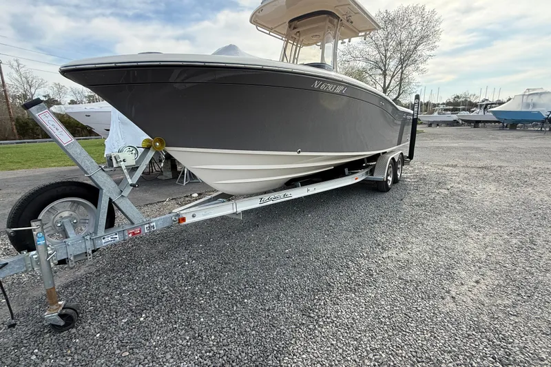 Slide: The Image of 2021 Grady-White Fisherman 236 boat on trailer in a gravel lot. - 2