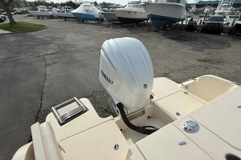 Slide: The Image of 2021 Grady-White Fisherman 236 with Yamaha outboard motor in a marina setting. - 21