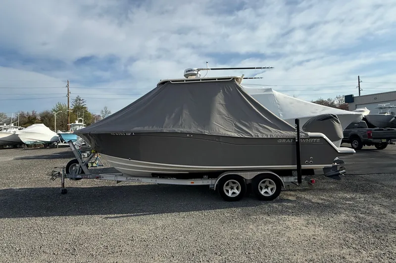 Slide: The Image of 2021 Grady-White Fisherman 236 boat covered on a trailer in a parking lot. - 3