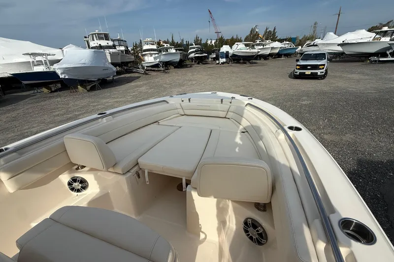 Slide: The Image of 2021 Grady-White Fisherman 236 boat interior with cushioned seating in a marina. - 7