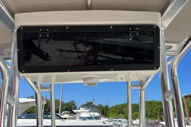 Slide: The Image of 2026 Key West 189 FS boat console with overhead storage, docked under clear blue sky. - 6