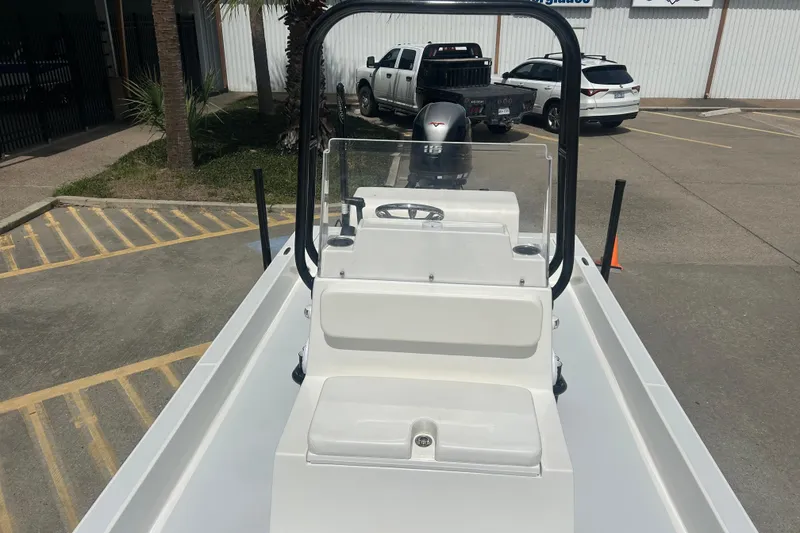 Slide: The Image of 2023 Shallow Sport 18 Sport boat in parking lot, showcasing console and seating. - 10