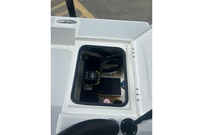 Slide: The Image of 2023 Shallow Sport 18 Sport boat compartment with wiring and equipment. - 17