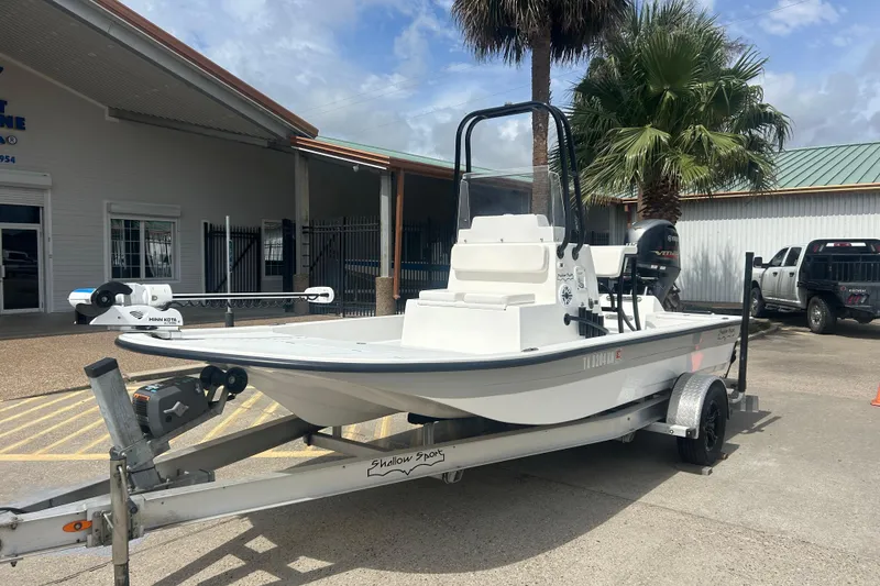 Slide: The Image of 2023 Shallow Sport 18 Sport boat on trailer, parked outside a building. - 5
