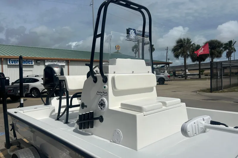 Slide: The Image of 2023 Shallow Sport 18 Sport boat with seating and motor, parked outdoors. - 6