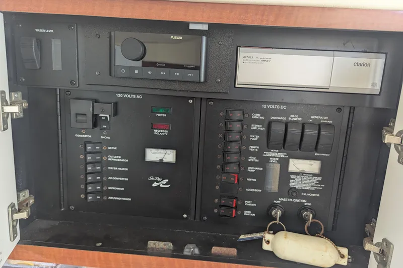 Slide: The Image of Control panel of a 2005 Sea Ray 290 Amberjack boat with various switches and gauges. - 17
