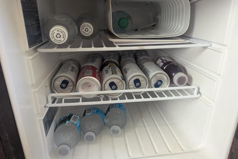 Slide: The Image of Mini fridge stocked with beverages on a 2005 Sea Ray 290 Amberjack boat. - 19