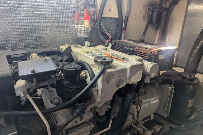 Slide: The Image of Engine compartment of a 2005 Sea Ray 290 Amberjack boat, showcasing mechanical components. - 25