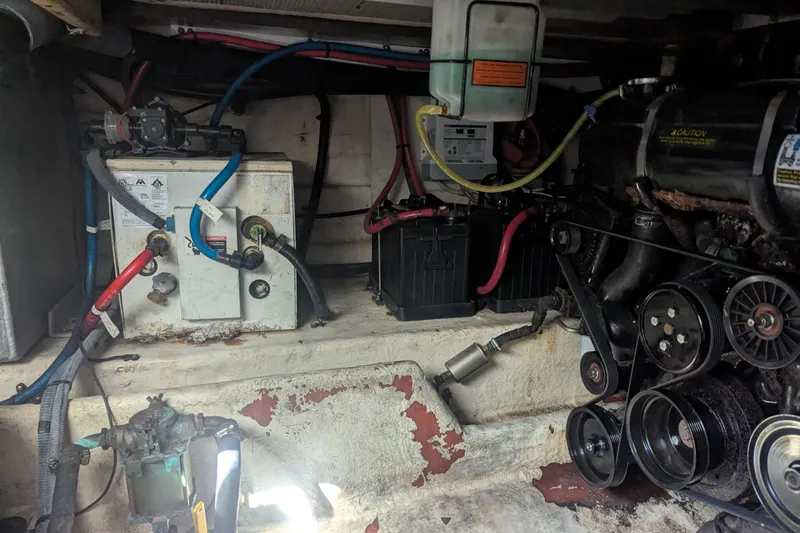 Slide: The Image of Engine compartment of a 2005 Sea Ray 290 Amberjack with visible batteries and wiring. - 26