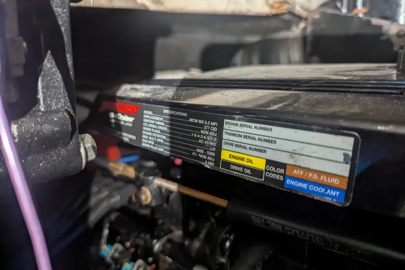 Slide: The Image of Engine compartment of a 2005 Sea Ray 290 Amberjack, showing Mercury engine specifications label. - 28