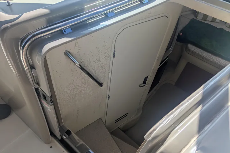 Slide: The Image of Interior cabin entrance of 2005 Sea Ray 290 Amberjack boat, featuring stairs and door. - 30