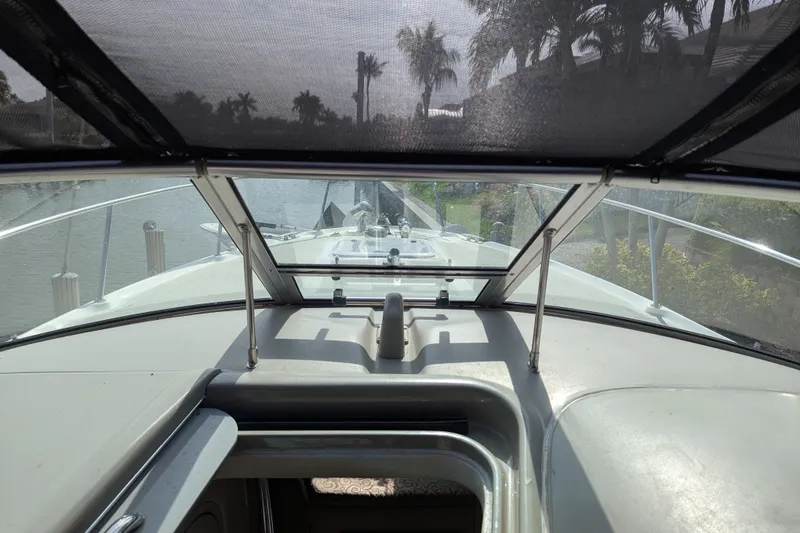 Slide: The Image of 2005 Sea Ray 290 Amberjack boat interior view with windshield and open hatch. - 31