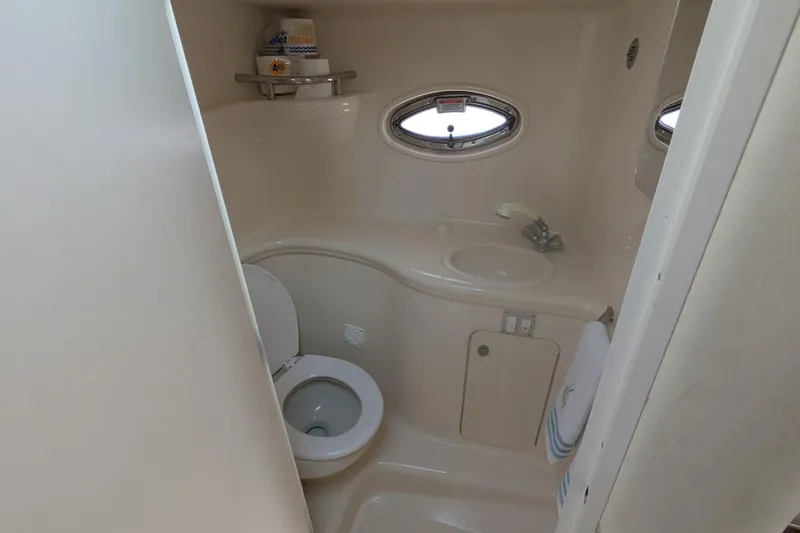 Slide: The Image of Compact bathroom in 2005 Sea Ray 290 Amberjack boat, featuring toilet and sink. - 32