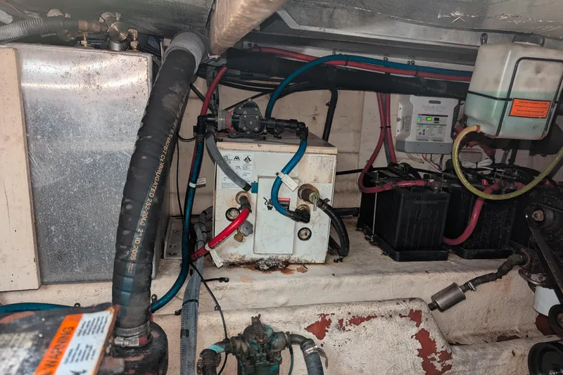 Slide: The Image of Engine compartment of a 2005 Sea Ray 290 Amberjack, showing batteries and wiring. - 33