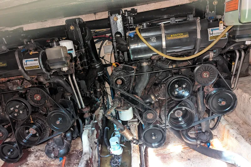 Slide: The Image of Engine compartment of a 2005 Sea Ray 290 Amberjack boat, showcasing dual engines and components. - 37