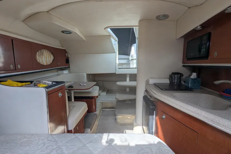 Slide: The Image of 2005 Sea Ray 290 Amberjack cabin interior with kitchenette and seating area. - 38