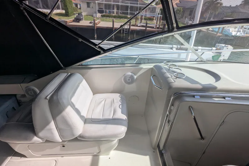 Slide: The Image of 2005 Sea Ray 290 Amberjack boat interior with white seating and helm station. - 39