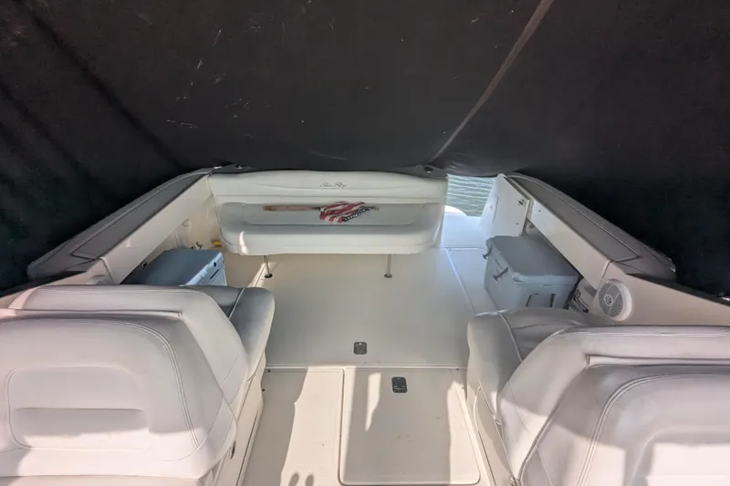 Slide: The Image of 2005 Sea Ray 290 Amberjack boat interior with white seating and covered deck. - 41