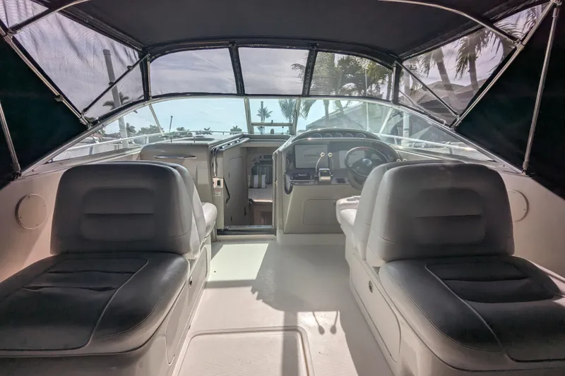 Slide: The Image of Interior view of 2005 Sea Ray 290 Amberjack boat cockpit with seating and controls. - 48