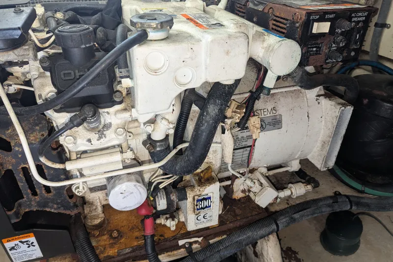 Slide: The Image of Engine compartment of a 2005 Sea Ray 290 Amberjack boat, showing mechanical components. - 49