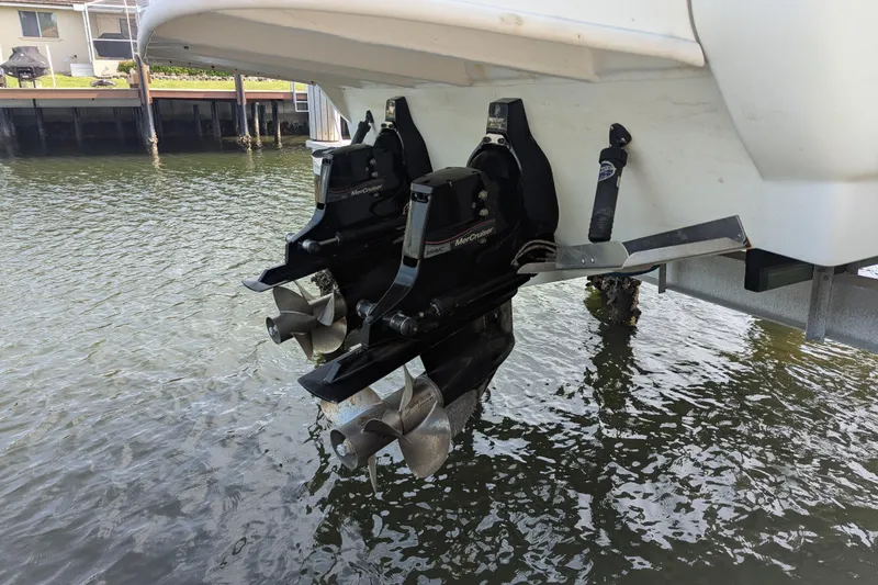 Slide: The Image of 2005 Sea Ray 290 Amberjack boat with dual MerCruiser outdrives in water. - 6