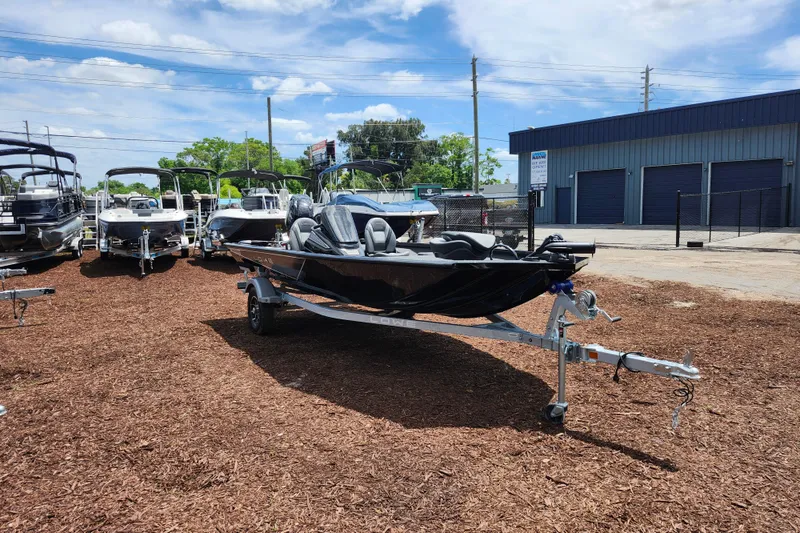The Image of 2026 Lowe Stinger 175C boat on trailer, displayed outdoors at dealership. - 1
