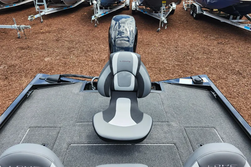 Slide: The Image of 2026 Lowe Stinger 175C boat interior with gray seating and carpeted deck. - 11