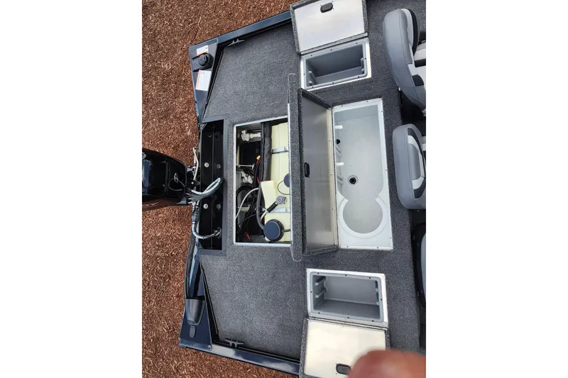 Slide: The Image of 2026 Lowe Stinger 175C boat interior with open storage compartments and seating. - 12