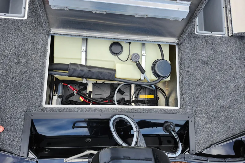 Slide: The Image of Open compartment of 2026 Lowe Stinger 175C boat showing internal components and wiring. - 16