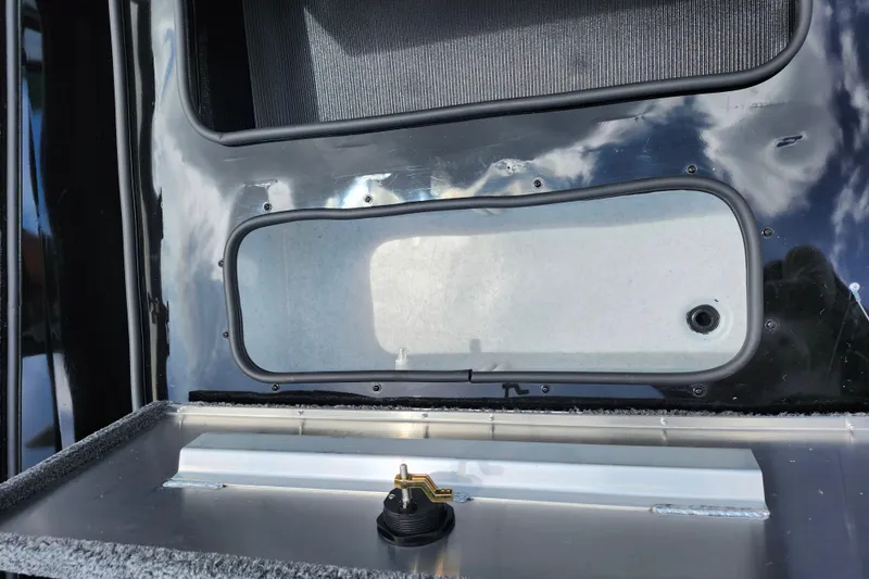 Slide: The Image of Lowe Stinger 175C 2026 boat compartment with latch and reflective surface. - 20