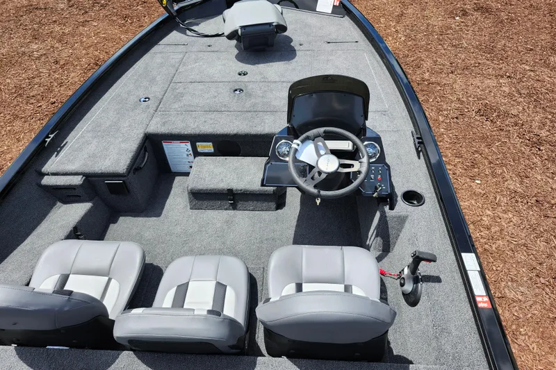 Slide: The Image of 2026 Lowe Stinger 175C boat interior with steering wheel and seating, showcasing modern design. - 25