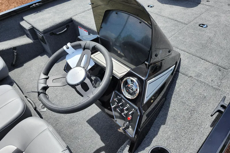 Slide: The Image of 2026 Lowe Stinger 175C boat dashboard with steering wheel and control panel. - 27