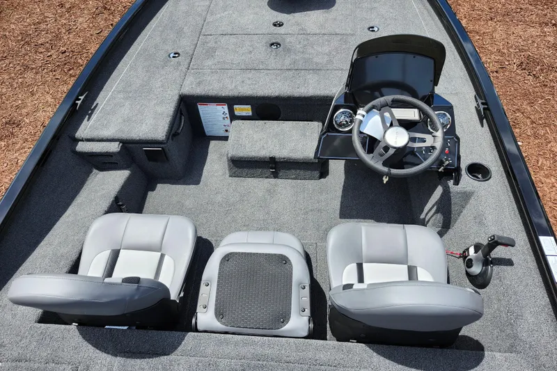 Slide: The Image of 2026 Lowe Stinger 175C boat interior with steering wheel and seating. - 28