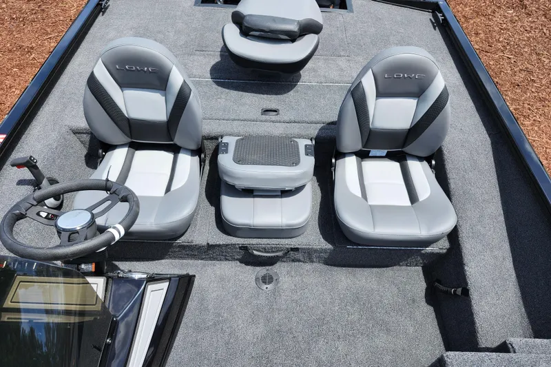 Slide: The Image of 2026 Lowe Stinger 175C boat interior with gray seating and steering wheel. - 29