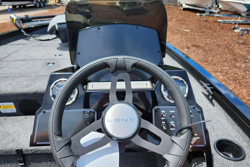 Slide: The Image of Steering console of 2026 Lowe Stinger 175C boat with modern controls and dashboard. - 31