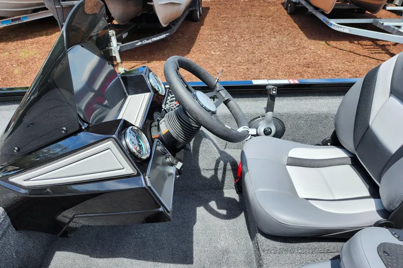 Slide: The Image of 2026 Lowe Stinger 175C boat interior with steering wheel and seat, showcasing modern design. - 32