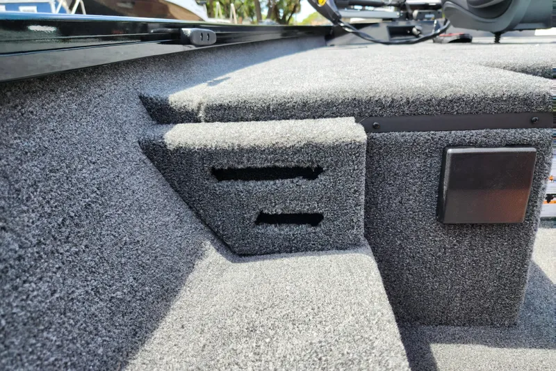 Slide: The Image of Interior of 2026 Lowe Stinger 175C boat with carpeted steps and storage compartments. - 34