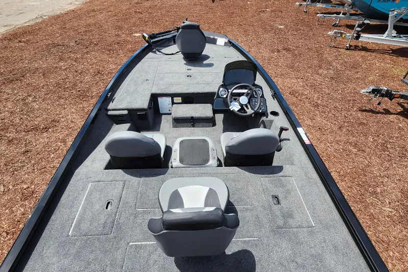 Slide: The Image of 2026 Lowe Stinger 175C boat interior with seating and steering console. - 35
