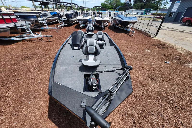 Slide: The Image of 2026 Lowe Stinger 175C fishing boat displayed outdoors among other boats. - 39
