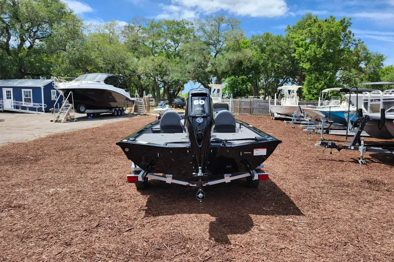 Slide: The Image of 2026 Lowe Stinger 175C boat on trailer, surrounded by trees and other boats. - 5