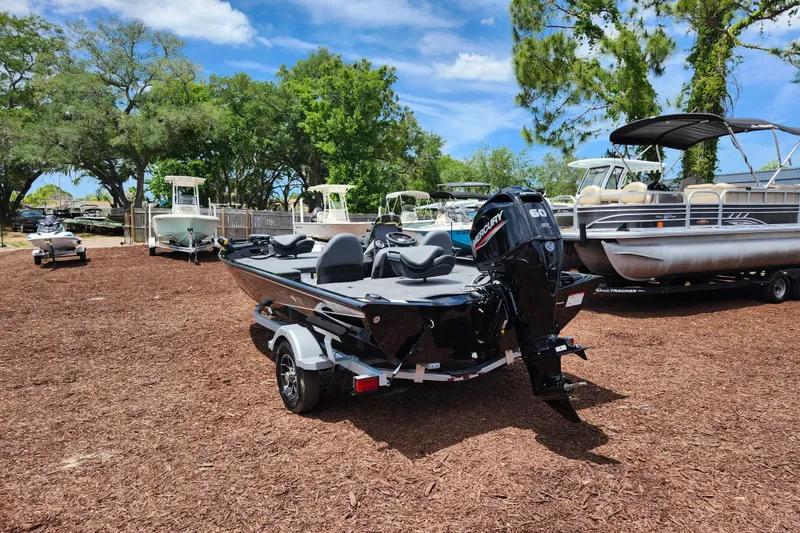 Slide: The Image of 2026 Lowe Stinger 175C boat with Mercury engine, parked outdoors on mulch. - 6