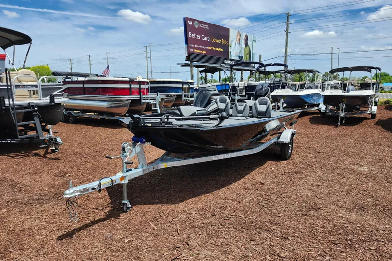Slide: The Image of 2026 Lowe Stinger 175C boat on display in outdoor showroom. - 8