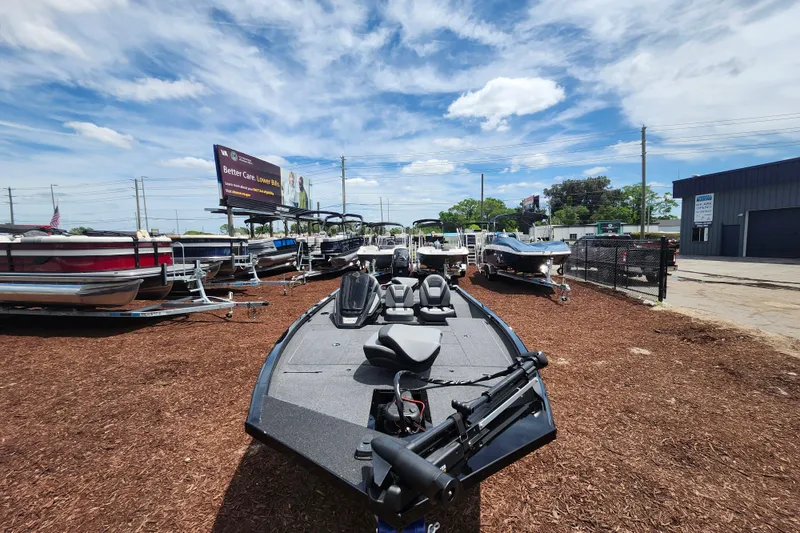 Slide: The Image of 2026 Lowe Stinger 175C boat displayed outdoors under a bright blue sky. - 9