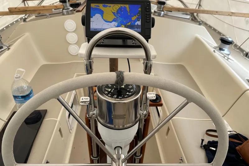 Slide: The Image of Cockpit of a 1987 O'Day 40 sailboat with navigation equipment and steering wheel. - 12