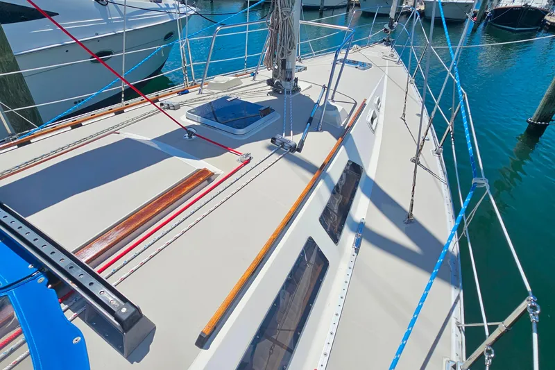 Slide: The Image of Interior of a 1987 O'Day 40 sailboat featuring wooden cabinetry and navigation station. - 15